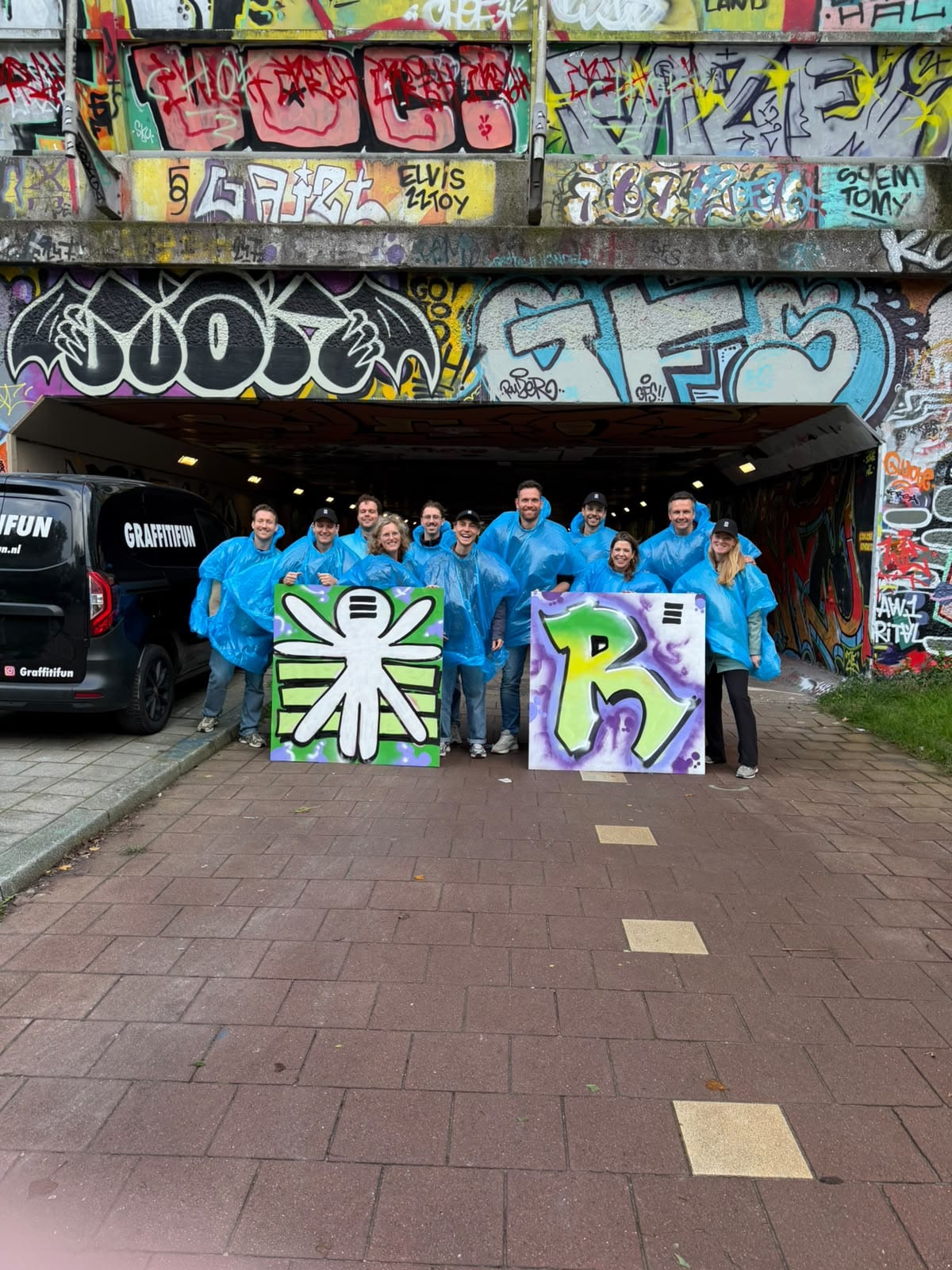 Het Repetive-team bij een graffiti-workshop, met twee zelfgespoten Repetive-borden